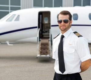 Pilot standing near a private jet